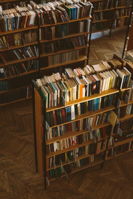 View of a cozy library featuring wooden bookshelves filled with assorted books, showcasing a rustic ambiance.